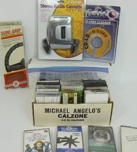 lot 80 image: Emerson AMFM Stereo Radio Cassette Player with Headphones EW96B New, Lens Cleaner, Sure-Grip Steering Wheel Cover NIB and Assorted Music Cassette Tapes...