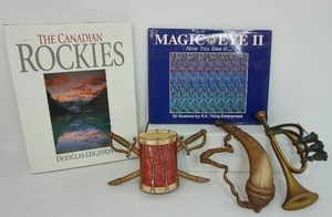lot 89 image: Sexton USA 576 Set of Bugle, Drum, Powder Horn Metal Wall Art, Book Magic Eye II Now You See It Vol. 2 by N.E. Thing enterprises, Douglas Leightons The Canadian Rockies Cocktail Table Book,