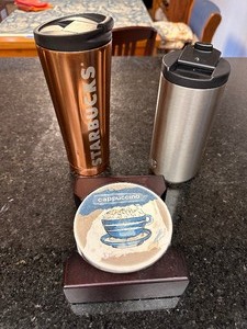 lot 273 image: Two Like New Starbucks Travel Mugs and Set of Coffee Themed Coasters