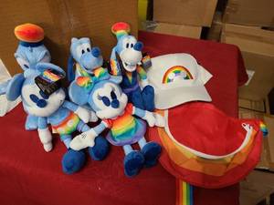 Nearly a full set of Disney Pride themed toys, hate and satchel