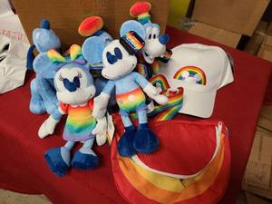Nearly a full set of Disney Pride themed toys, hate and satchel