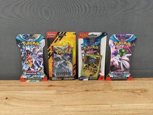 lot 28 image: (3) Pokemon Scarlet & Violet Paradox Rift Booster Packs and (1) Pokemon Sword & Shield Silver Temptest Booster Pack  I