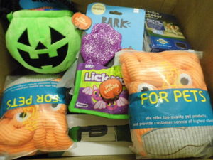 Box of Assorted dog toys and accessories
