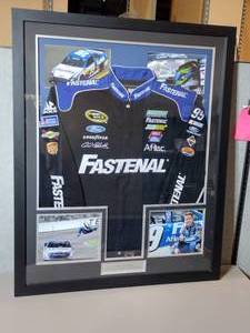 lot 28A image: Framed Collage featuring the Fastenal Jacket (JH Designs) worn by Carl Edwards 2007 NASCAR Busch Series Winner