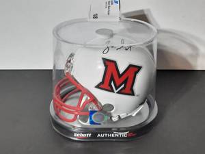lot 108 image: Signed Schutt Sports Riddell Mini Helmet Miami of Ohio Red Hawks. Measures approx 7 L X 5 W X 6 T.