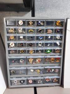 lot 247 image: Multi-Sports Team logo pins or team medallions in a storage organizer with multiple drawers