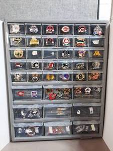 lot 250 image: Multi-Sports Team logo pins or team medallions in a storage organizer with multiple drawers