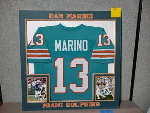 lot 216B image: Collage of Dan Marino #13 Miami Dolphins Jersey and Photos. Professionally matted. 32 x 32