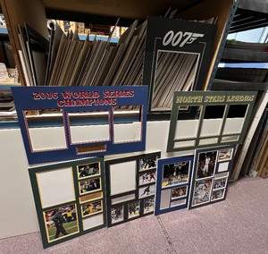 lot 467 image: Entire shelf of mat boards, some have been prepped for display and some have pictures and name plates