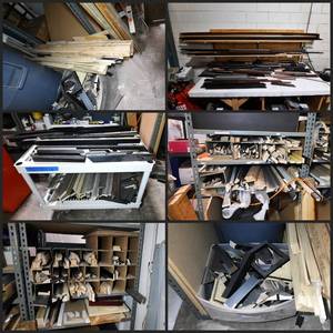 lot 518 image: All of the wood moulding pieces on the table and shelves.