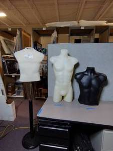 lot 520 image: (3) Torso Mannequins. One is on a stand and is 64 inches high. The other two stand 33 and 23 inches high.