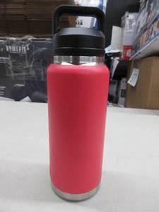 lot 124 image: YETI Rambler 36 oz Bottle, Vacuum Insulated, Stainless Steel with Chug Cap, Rescue Red, New, Slightly Dented (See Photos).