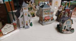 lot 19 image: Small Christmas Houses, 164th Scale Coca-Cola Semi, Ceramic Menards Store, Glass Vase, Glass Bells, Keepsake Ornament, and More
