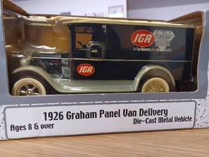lot 27 image: Spec Cast 1952 Chevrolet 3100 Panel Die Cast Metal Collector Bank in Original Box, and an IGA 1926 Graham Panel Van Delivery Die Cast Metal Bank in Original Box