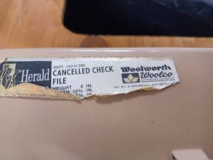 lot 28 image: Woolworth - Woolco Metal Cancelled Check File 10.75-inches Long and a New Musical Boutique Brown Nativity Scene Ornament Kit in Original Package - Plays Silent Night