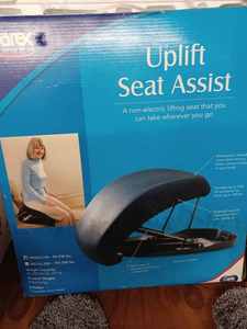 lot 73 image: Uplift Seat Assist - Like New Non-Electric Lifting Seat that you can take wherever you go in the Original Box Works for 85lbs. To 230lbs., and a New Mainstays Performance Contour Bath Rug