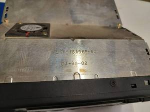 lot 86 image: AM-FM Radio from a 2002 Ford F-Series Pickup - CD Player Not Working, and a Box of Assorted Charge Cords and Electronic Cords