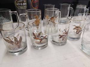 lot 87 image: Assorted Drink Glasses including Miller Lite, Larry The Cable Guy, Ducks and Geese Glasses, Tabasco Mug, 60th Anniversary of Chesters at Powder Ridge, Anheuser Busch Mugs, Southern Comfort