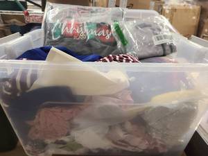 Storage bin of new clothing still in wrap, mostly womens
