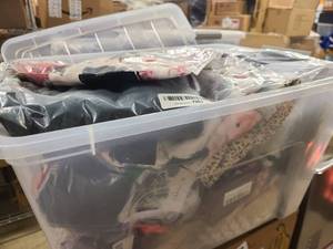 Storage bin of new clothing still in wrap, mostly womens