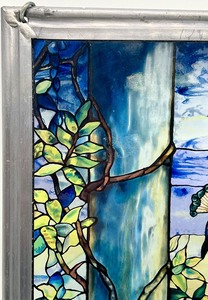 lot 26 image: Marked GLASSMASTER 1990 LOUIS C. TIFFANY Reproduction of TIFFANYS PEACOCK AND WISTERIA Satined Glass Sun Catcher Window Panel