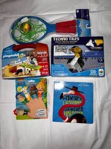 lot 23 image: Playmobil Vet Kit, Techo Tiles Penguin, Bubble Guppies Finger Puppets, Splash Ball set & Flamingo Book