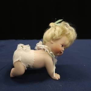 lot 35 image: DIONNEPORCELAIN CRAWLING BABY DOLL