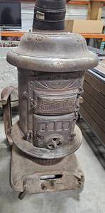 lot 49 image: Cast Iron Round Oak Wood Stove with Stand