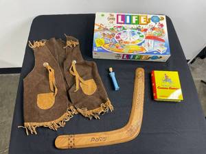 lot 161 image: Play Vest, Game of Life (unknown if all pieces are there), Curious George Book, Boomerang