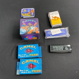 lot 257 image: Misc Camel Logo Games, Darts in Case & Glass Paperweight Ruler