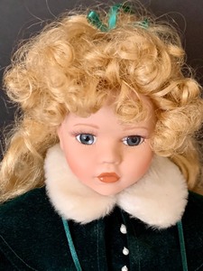 lot 104 image: Vintage Porcelain Doll Wearing a Holiday Plaid Dress