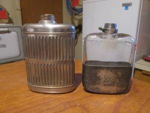 (DLR) 2 Vintage Glass Hip Flasks - Left is Stainless Steel Outer No Markings Right is Metal Bottom Outer with Initials and Date 1898 Ingraved  No Other Markings - Both Are Missing Lids