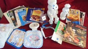 lot 15 image: Pillsbury Doughboy Lot- Cookbooks, Bank, Clock, Potholders and Misc