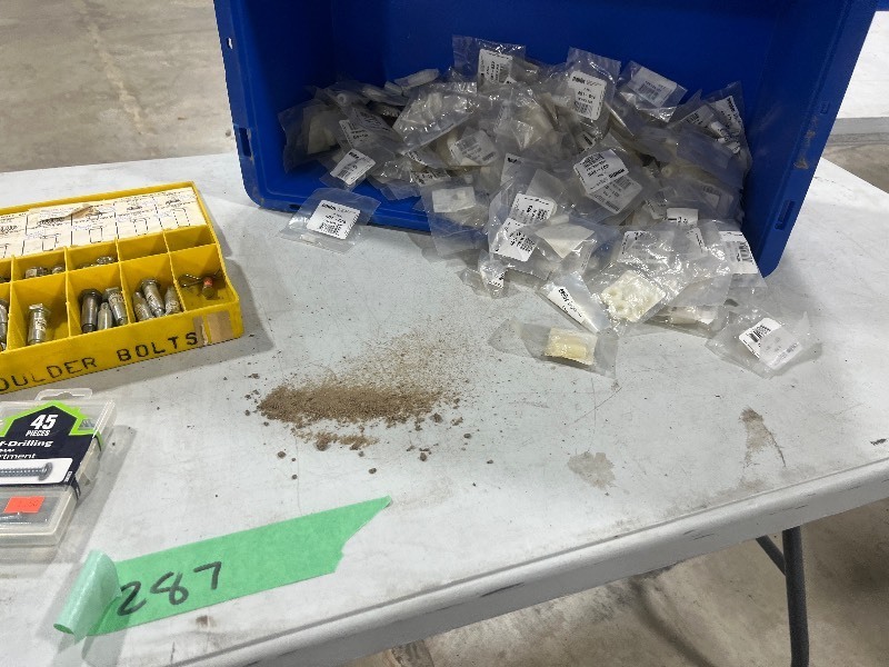 TABLE FULL OF SHOULDER BOLTS, PLASTIC SPACERS, & CROSS DOWELS
