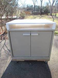 lot 188 image: Metal Cabinet on wheels with painted wood top.
