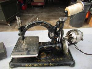 lot 233 image: Antique Portable Sewing Machine in wood case. Western Electric