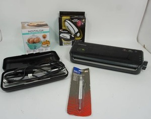 lot 234 image: Home Essentials for the Kitchen...Nostalgia MyMini 7-Egg Cooker, TouCan Can Opener, Electric Knife with Case...