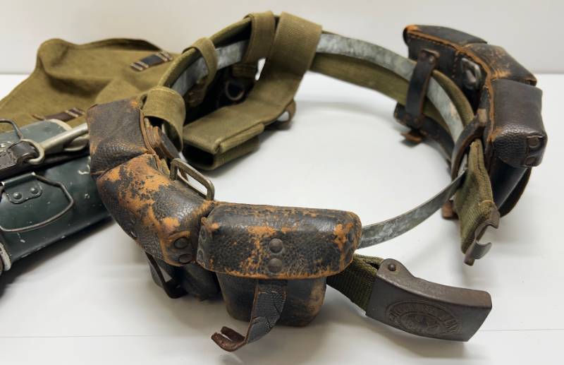 lot 125 image: WWII Tropical Belt With Buckle, K98 Leather Ammo Pouches, M31 Canteen, Bread bag & Bayonet Rig With Metal Display Ring