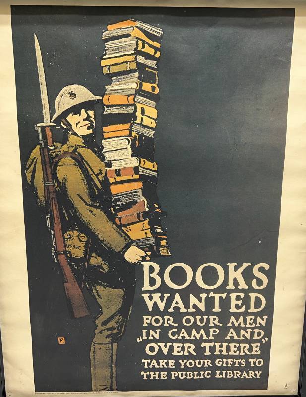 lot 213 image: Framed 1960s Repro Books Wanted For Our Men In Camp And (Over There) Take Your Gifts To The Public Library  Military Book CLub Poster 18 x 22 (Pinholes Present In Corners)