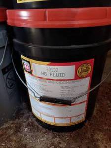 lot 115 image: new unopened 5 gal bucket of HG TRANSHYDRAULIC fluid