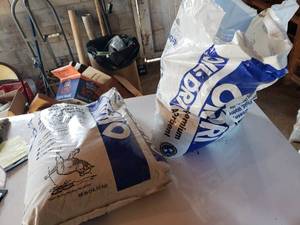 lot 118 image: bags of floor dry one unopened the other is half full