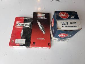 lot 223 image: (2) boxes of new CHAMPION spark plugs and a box of vintage spark plug cleaning compound