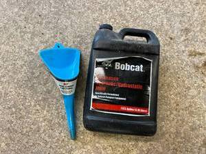lot 161 image: Full Bobcat 1 Gallon All-Season Hydraulic Fluid & Funnel