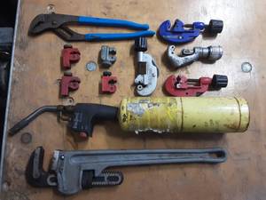 Tubing cutters, 18 pipe wrench, channel lock pliers, map gas torch