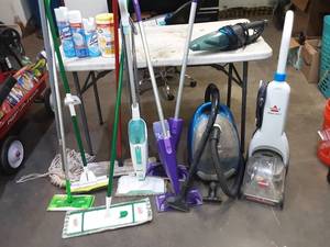Bissel carpet cleaner, vacuum and assorted other cleaning supplies