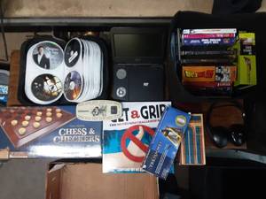 portable dvd player with assortment of dvds and games