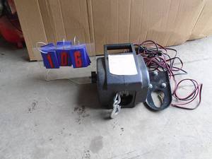 2000 lb 12 volt winch with cable, power cord, controller & hitch mount. As shown.