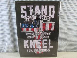 lot 159 image: (EC1) Stand For The Flag  Kneel For The Cross Embossed Tin Sign with Rolled Back Edges 16 34 x 12 - New in Wrap