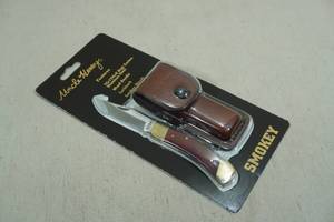 lot 24 image: Uncle Henry Smokey Folding Knife with Leather Sheath