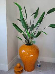 A large Speckled Orange Covered VasesPlanter with Greenery.